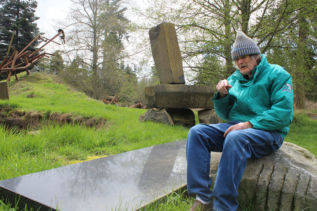 Hank Nelson sits near one of his installations at Cloudstone Sculpture Park, a 20-acre display near Freeland of his stone and steel work. Nelson and artist Sue Taves are being honored April 21 during International Sculpture Days. Photos by Patricia Guthrie/Whidbey News Group