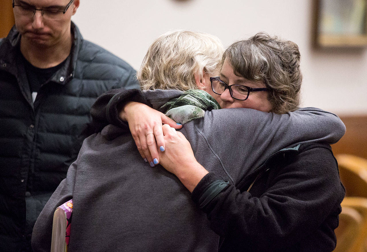 Tiffany Ferrians (right) hugs Tamara Fralic after two former Island County corrections officers were sentenced on Tuesday at the Whatcom County Courthouse in Bellingham over the death of Keaton Farris. Ferrians is the mother of Harris. Fralic is Farris’ aunt. (Andy Bronson / The Herald)