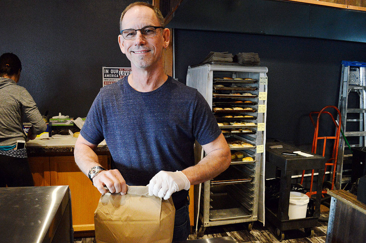 Store owner John Auburn packs up an order of bagels at the recently opened location of Whidbey Island Bagel Factory. Photo by Laura Guido/Whidbey News Group