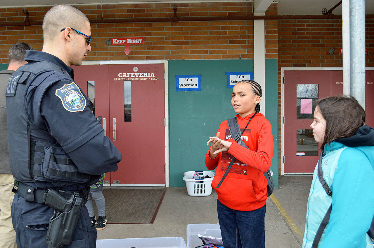 School Resource Officer Nathan Padrta talks to fifth graders Tyshawn Miller and Kaiya Castellanos at Oak Harbor Intermediate School. The resource officer has an office in the high school, but visits all the schools for both safety reasons and to build positive relationships with the kids, according to Capt. Bill Wilke, Oak Harbor Police Department. Photo by Laura Guido/Whidbey News Group