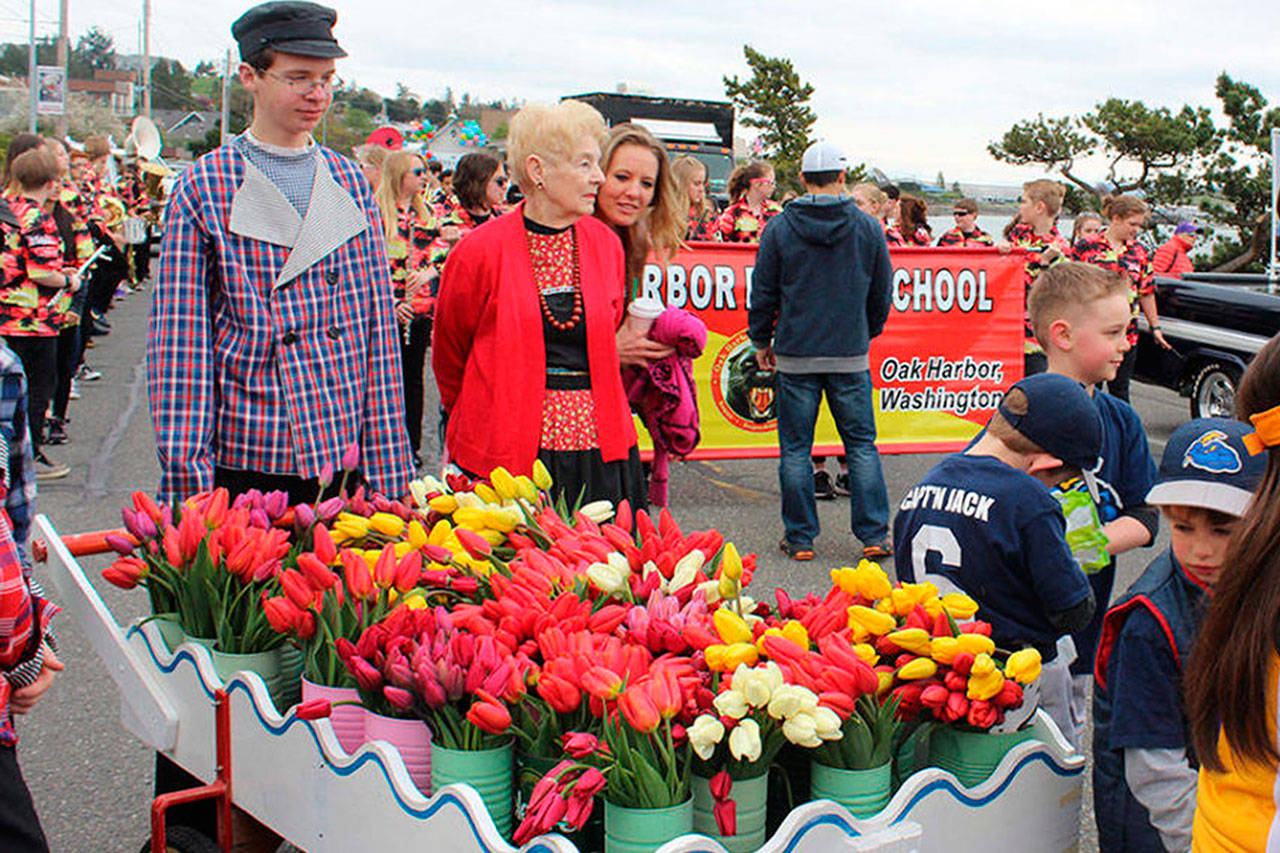 During the 2017 Holland Happening parade, Sande Mulkey (in red jacket) accompanies Jacob Hutson, left, and the traditional Dutch tulip cart. Mulkey is this year’s Grand Marshal for Saturday’s parade that begins at 11 a.m.