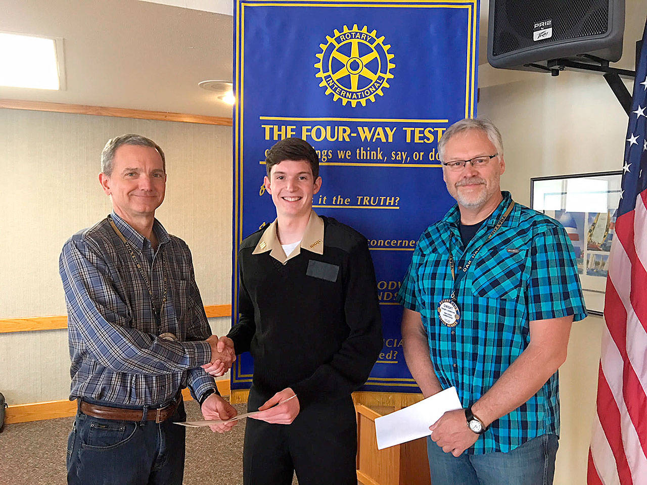 Photo submitted                                Rotary Student of the Month Gabe Salinger stands with Rotary Club President Steve Powers, left, and Oak Harbor High School Principal Dwight Lundstrom.