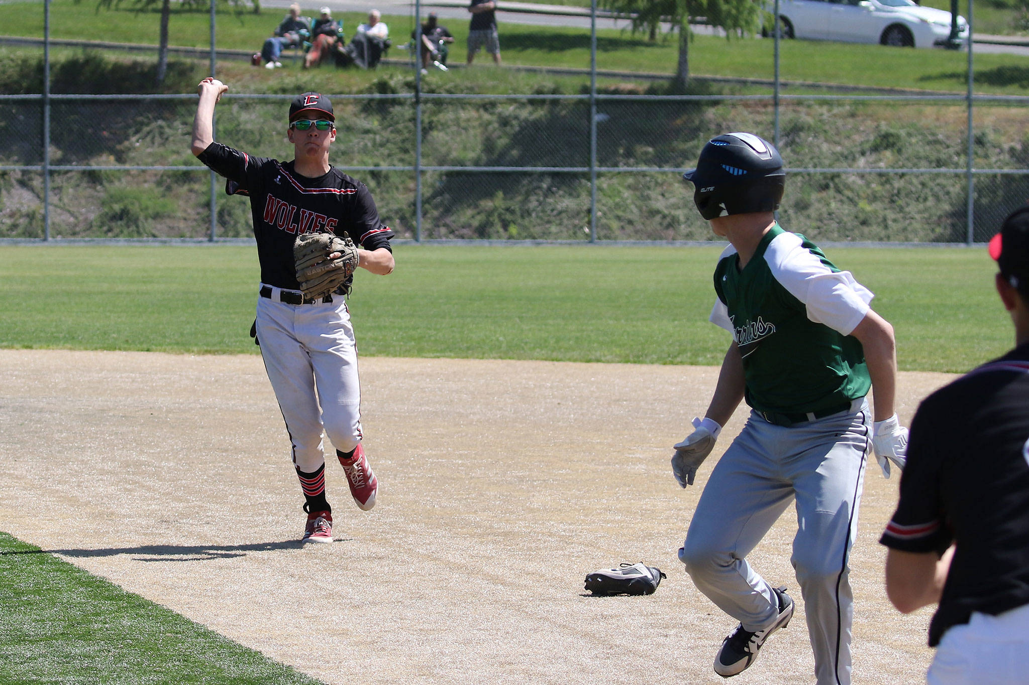 A Charles Wright players runs out of his shoe while being chased by Coupevilles Nick Etzell.(Photo by John Fisken)