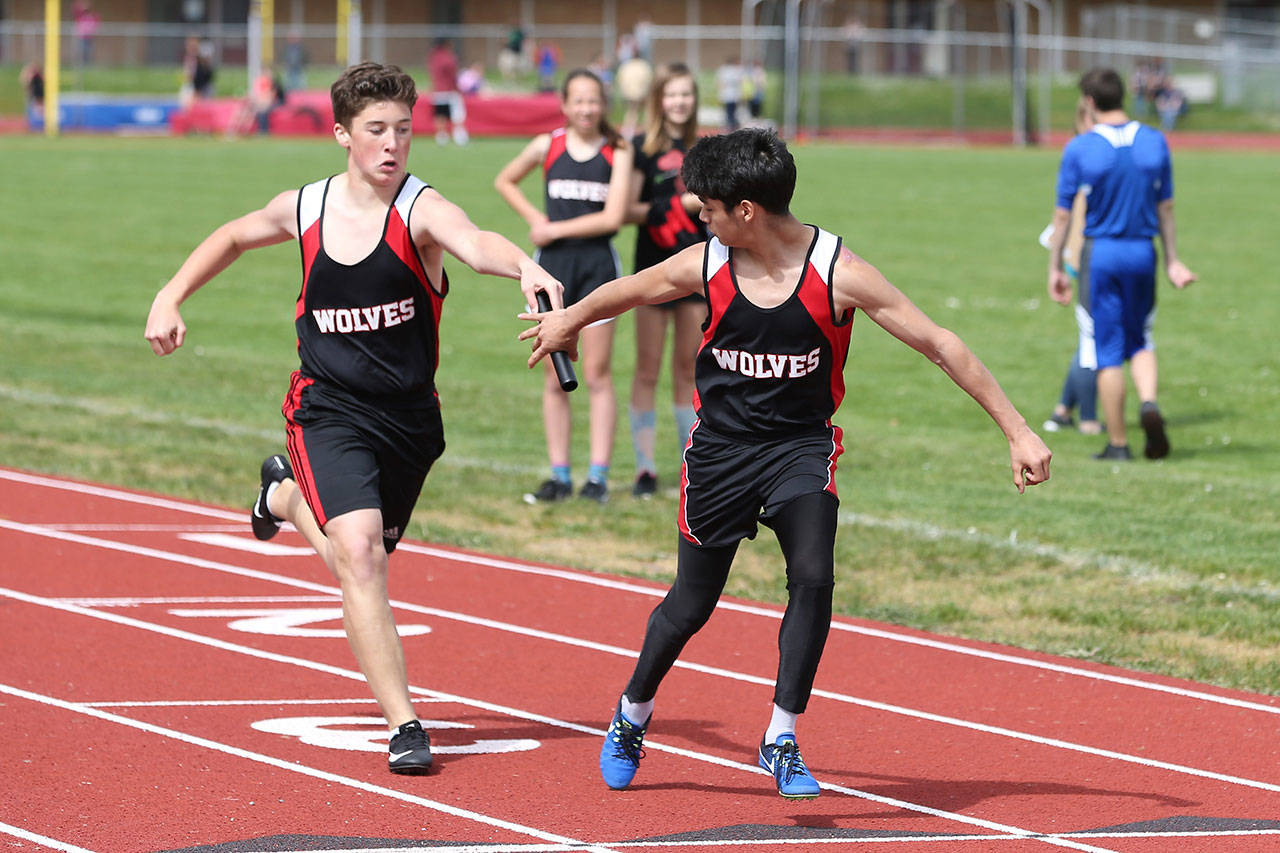 Gabe Shaw of Coupeville Middle School hands off to DJ Stadler at a home meet May 8. (Photo by John Fisken)