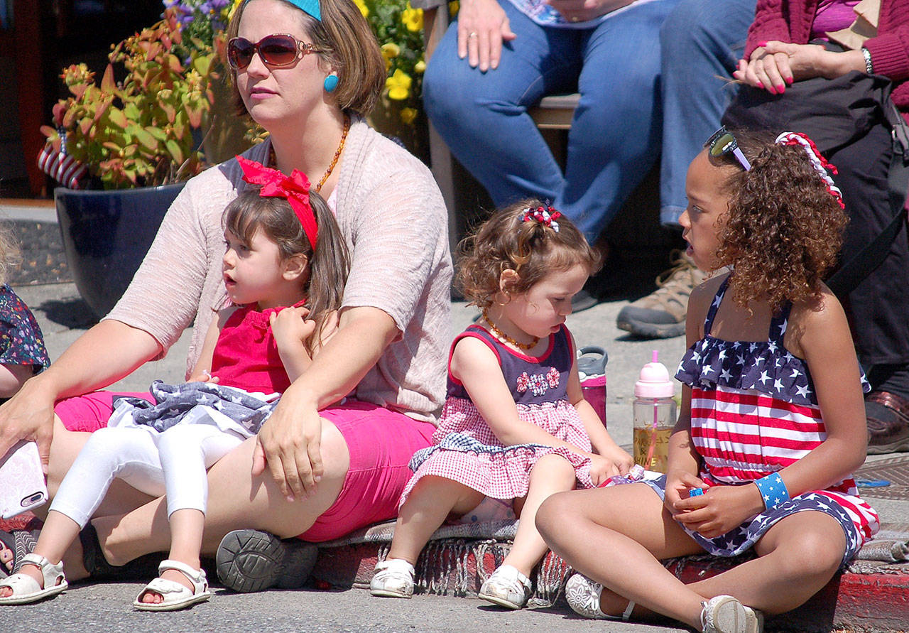 Photo by Joan Soltys / Whidbey News-Times                                Dressed in red, white and blue, young Allie, Paizley and Emmy Hansen of Coupeville were among the many kids who came out to watch the Memorial Day parade.