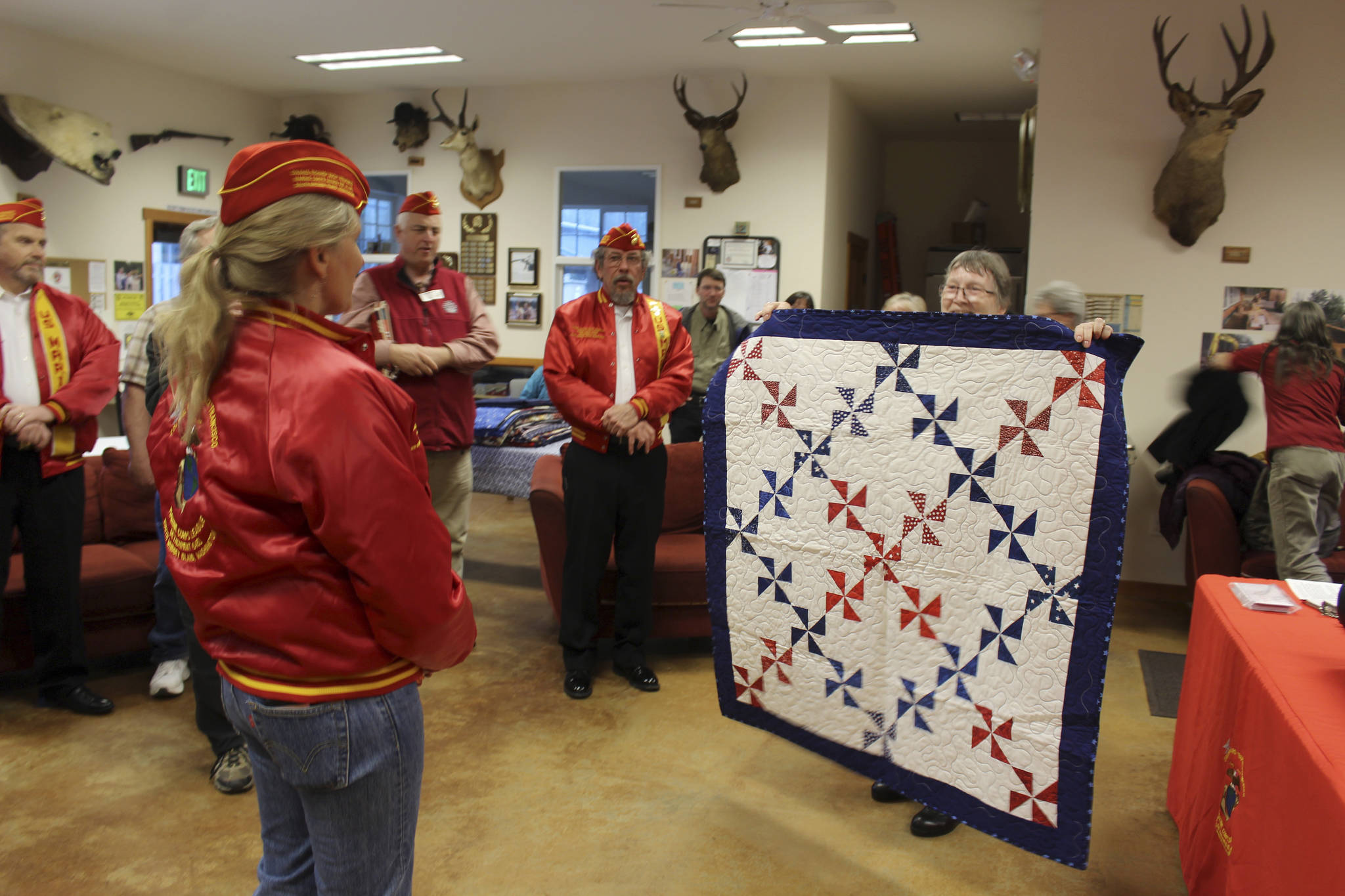 “M. J.” Margaret Johns receiving her quilt from Anita Smith.