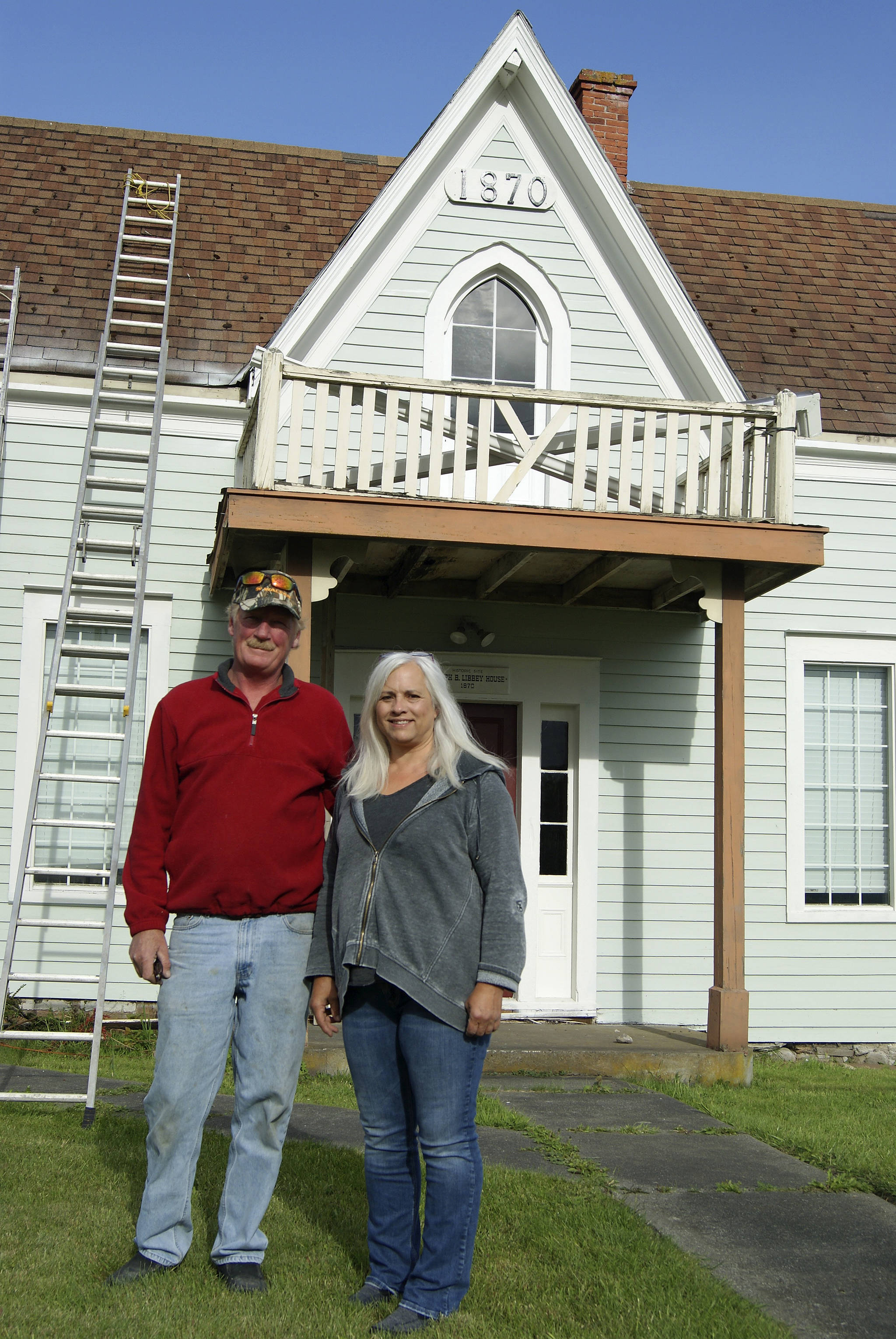 Photo by Maria Matson / Whidbey News Group                                Dennis McCaslin and Cindy Balthazar stand in front of the Joseph B. Libbey House, a historic structure built in 1870 that new owner McCaslin is working to restore.
