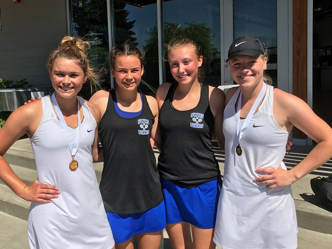 Coupeville’s Payton Aparicio, left, and Sage Renniger, right, pose with South Whidbey’s Alison Papritz, second from left, and Mary Zisette at the state 1A tennis tournament. The Coupeville pair placed fourth in the tournament while the Falcons finished second. (Photo courtesy of Ken Stange)