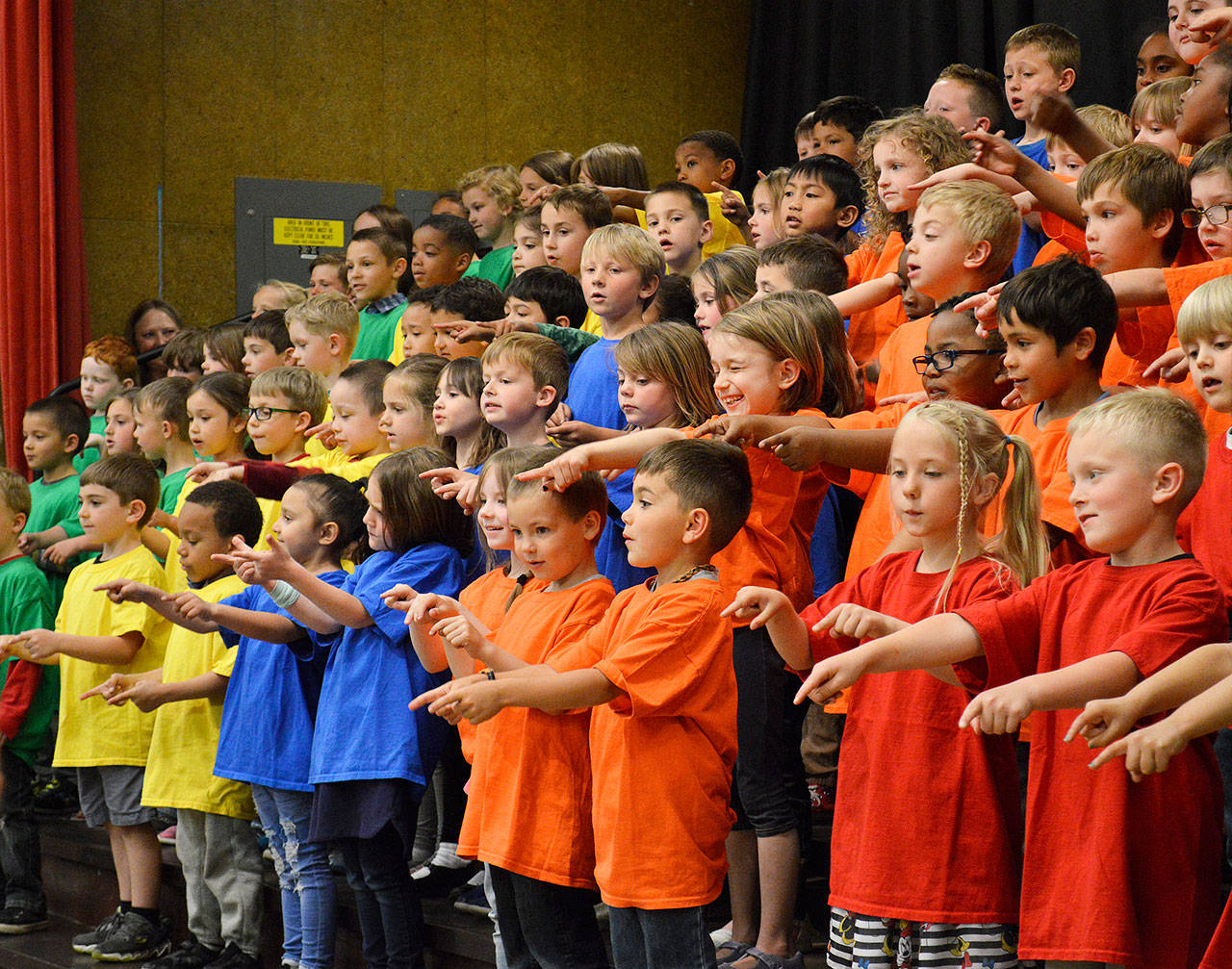 Kindergartners from Crescent Harbor Elementary School point to their teachers as they sing a thank you song during a rehearsal Thursday for the class’s World Music program. Photo by Laura Guido/Whidbey News Group