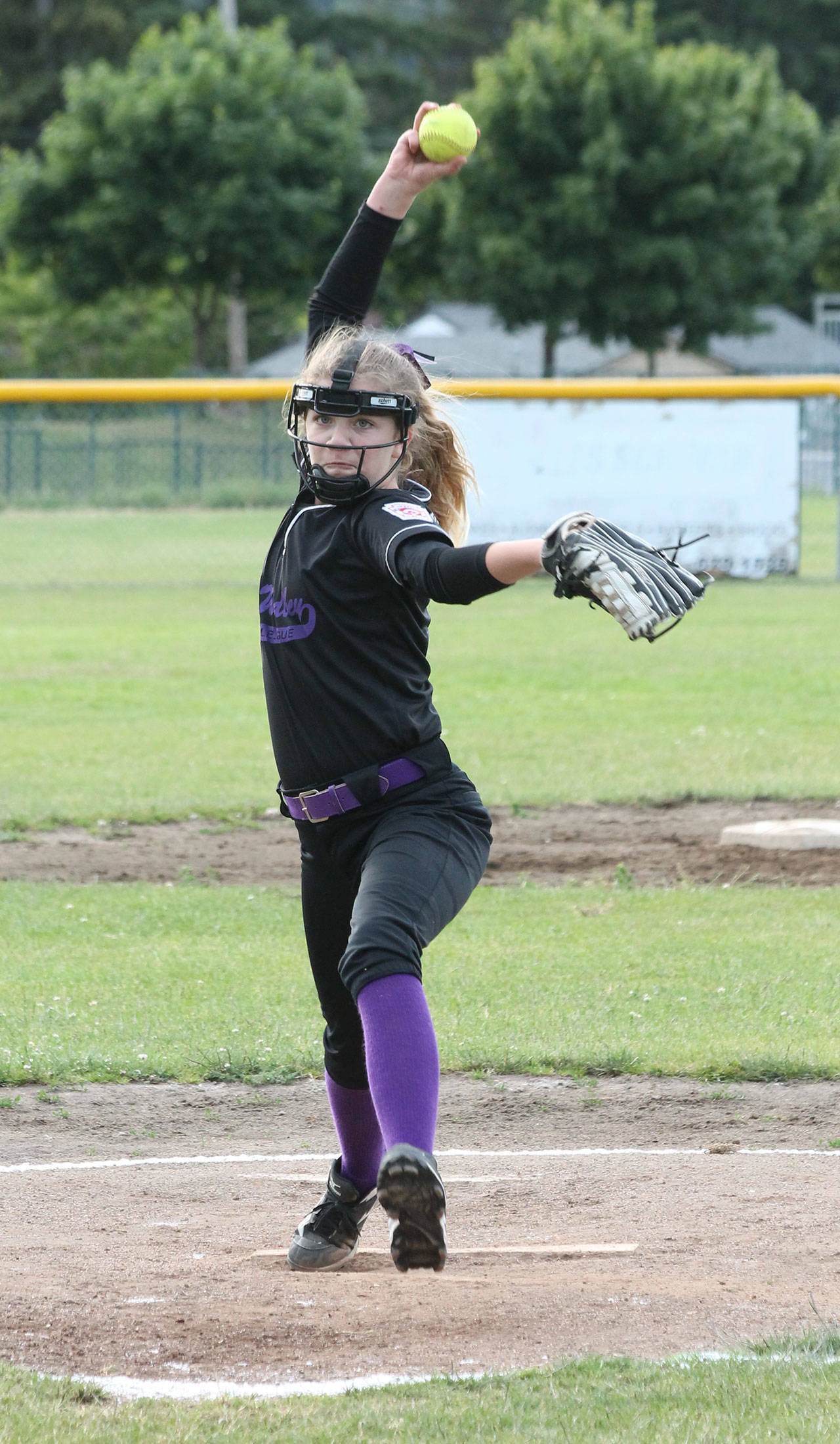 The Bat Busters’ Reese Wasinger hurls a pitch in her 15-strikeout win over the Blue Dragons Wednesday. (Photo by Jim Waller/Whidbey News-Times)