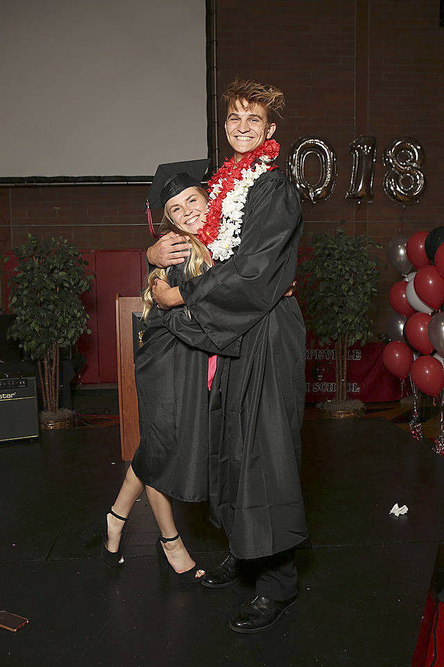 Hope Lodell and Ariah Bepler hug each other on stage.