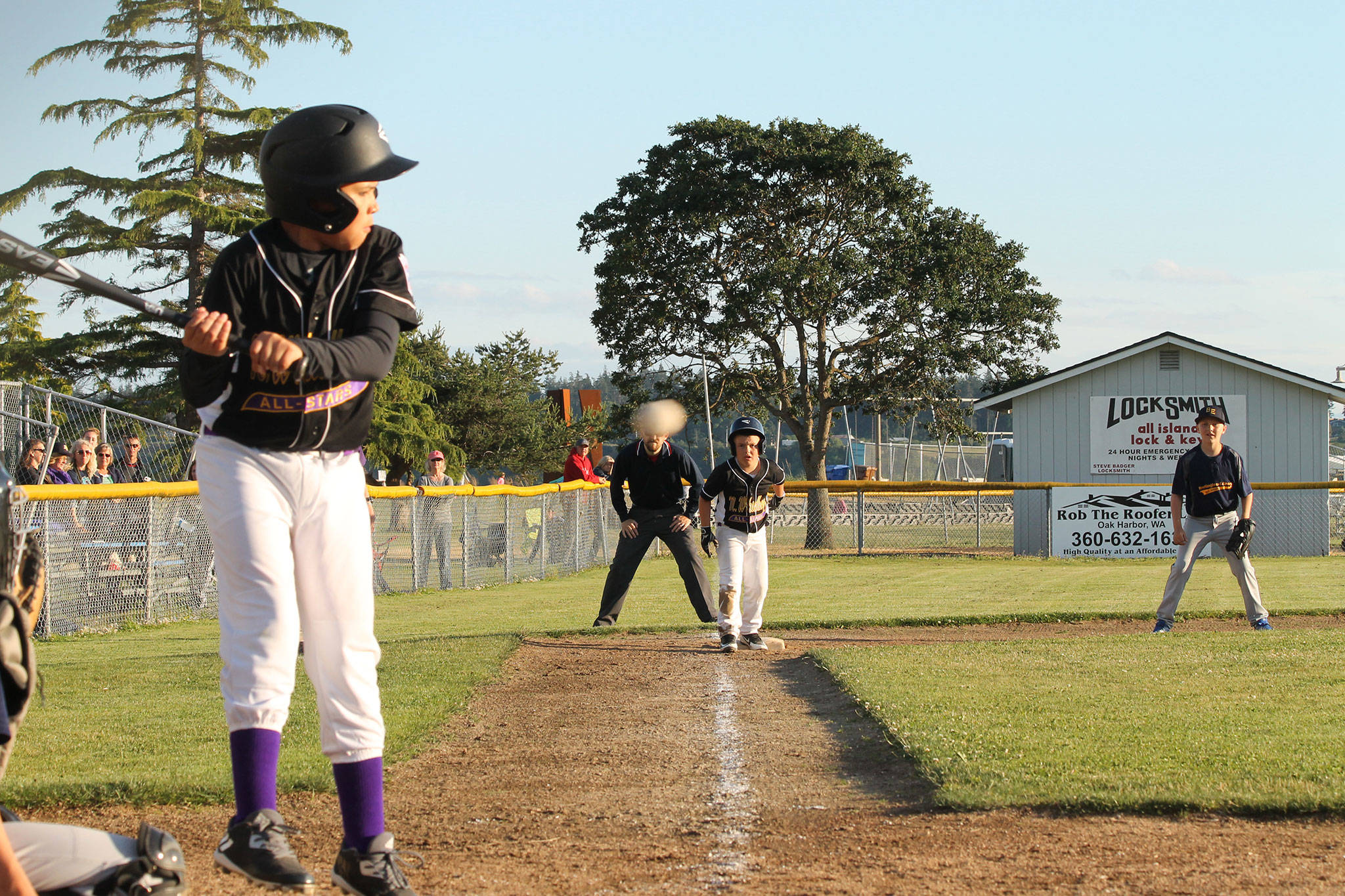 North Whidbey’s Nikko Gonzales dodges an inside pitch with teammate Easton Burton perched on third. Gonzales eventually drove in Burton in the sixth inning during North Whidbey’s rally. (Photo by Jim Waller/Whidbey News-Times)