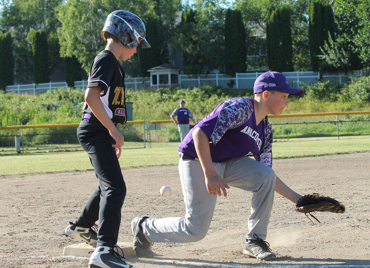 Parker Anderson sees the ball get by the Anacortes third base. Anderson then beat the throw home to score North Whidbey’s second run of the game. (Photo by Jim Waller/Whidbey News-Times)