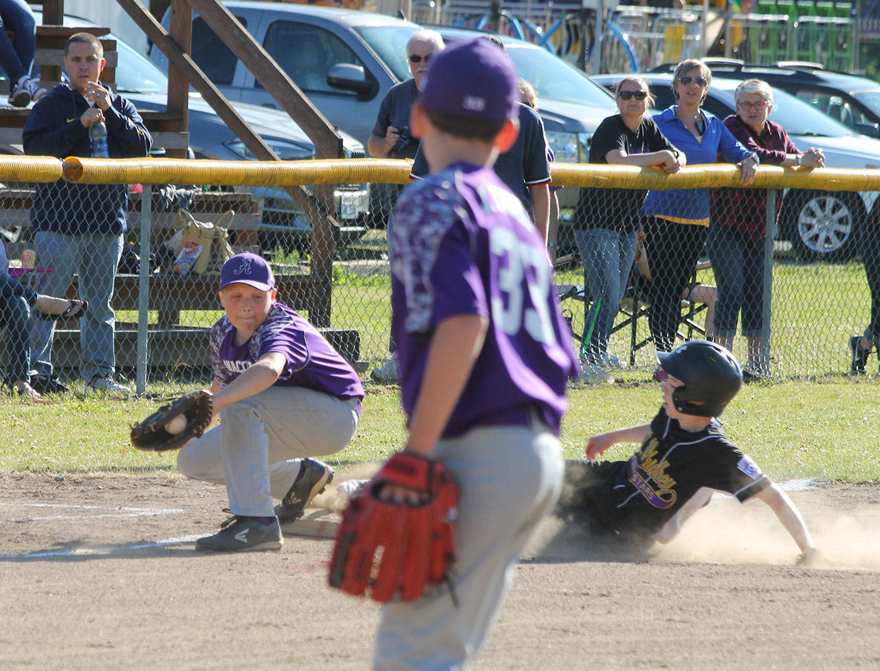 Nate Moore slides into third base ahead of a tag. (Photo by Jim Waller/Whidbey News-Times)