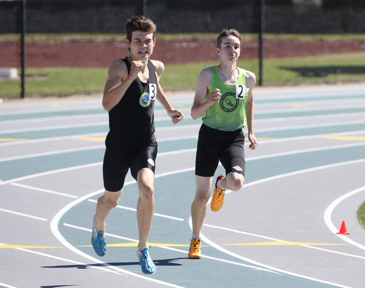 Coupeville’s Danny Conlisk, right, runs to third place in the 400 meters at the Junior Olympics regional meet last weekend. (Photo by John Fisken)