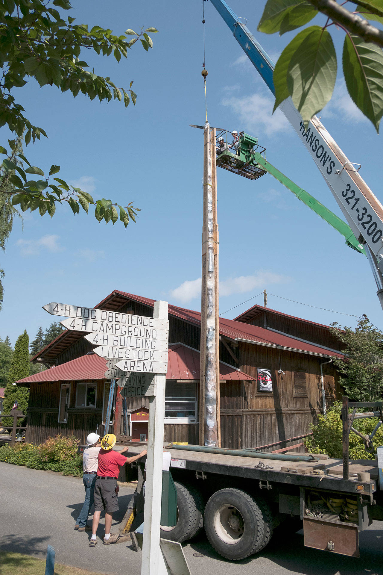 On June 6, the 50-foot story pole was wrapped                                in a wood sleeve before being taken down for safety reasons and preservation assessment. Photo provided by George Masters
