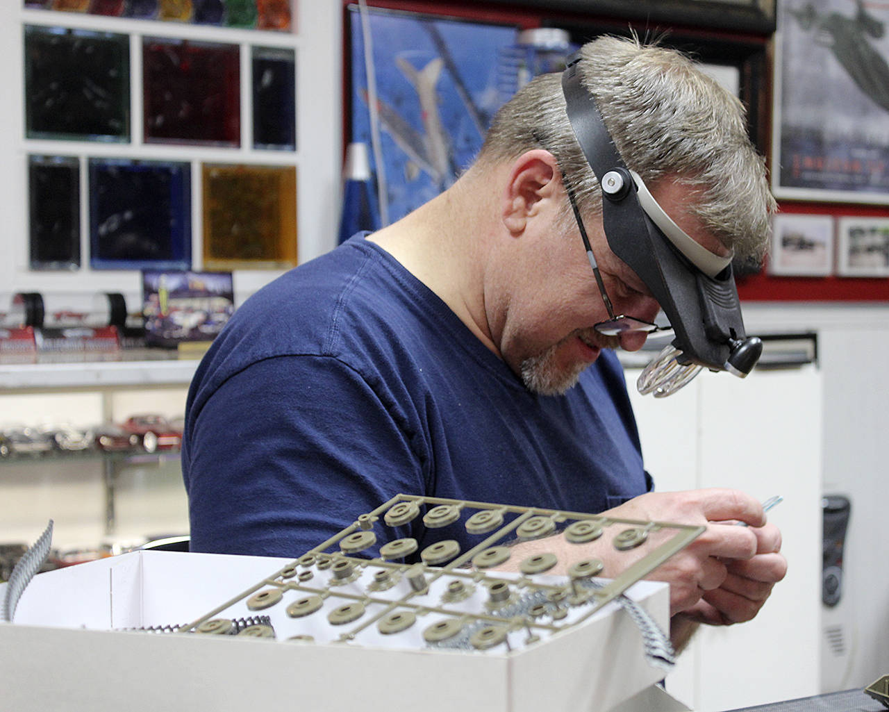 Photos by Patricia Guthrie                                Roy Schlicht works on assembling a small-scale plastic model kit during a recent Friday evening gathering of Whidbey Island veterans who are known as “modelers.”