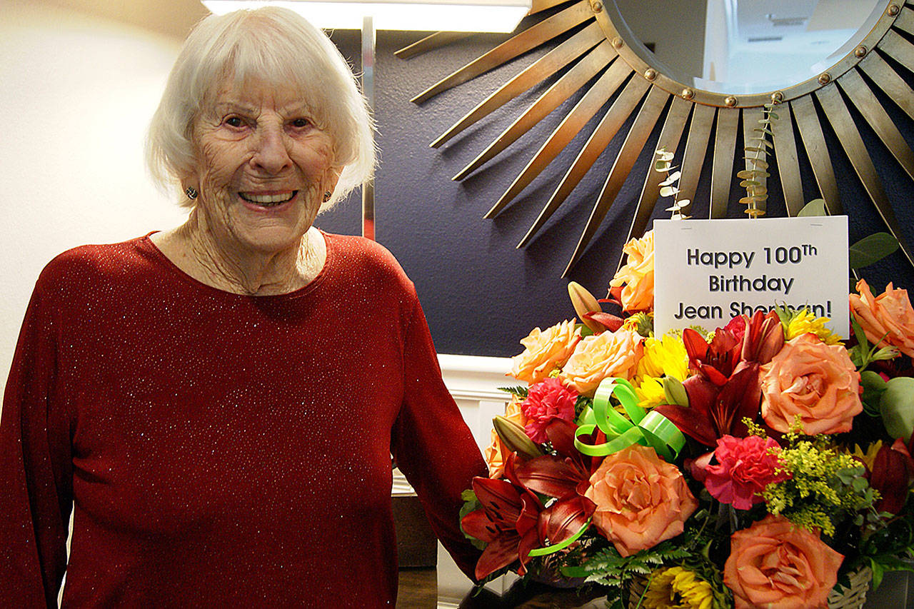 Photo by Maria Matson / Whidbey News Group.                                Jean Sherman stands with her 100th birthday bouquet.