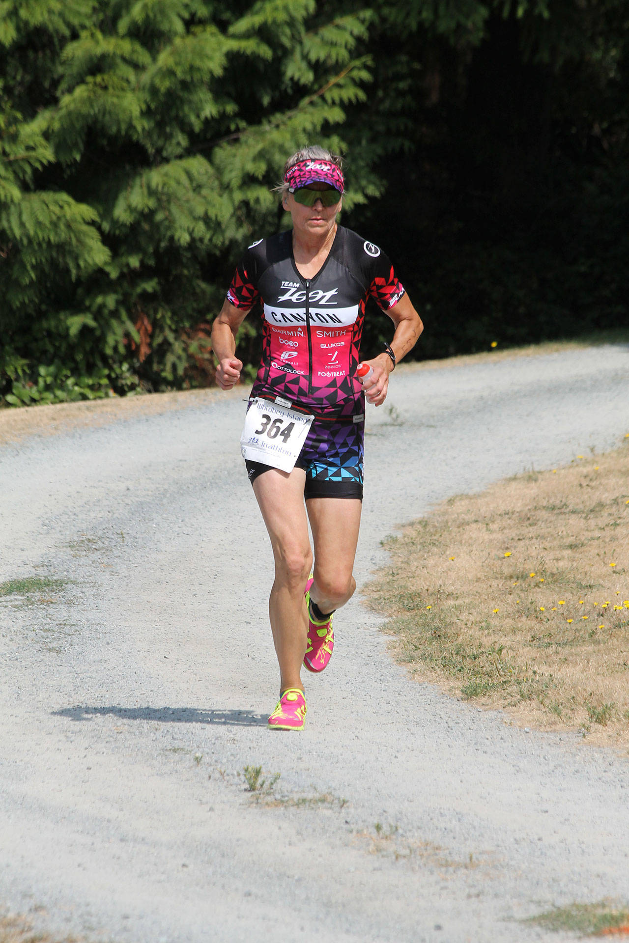 Christina Bromme runs through the trails of Langley’s Community Park during last weekend’s Whidbey Island Triathlon. (Photo by Jim Waller/Whidbey News-Times)