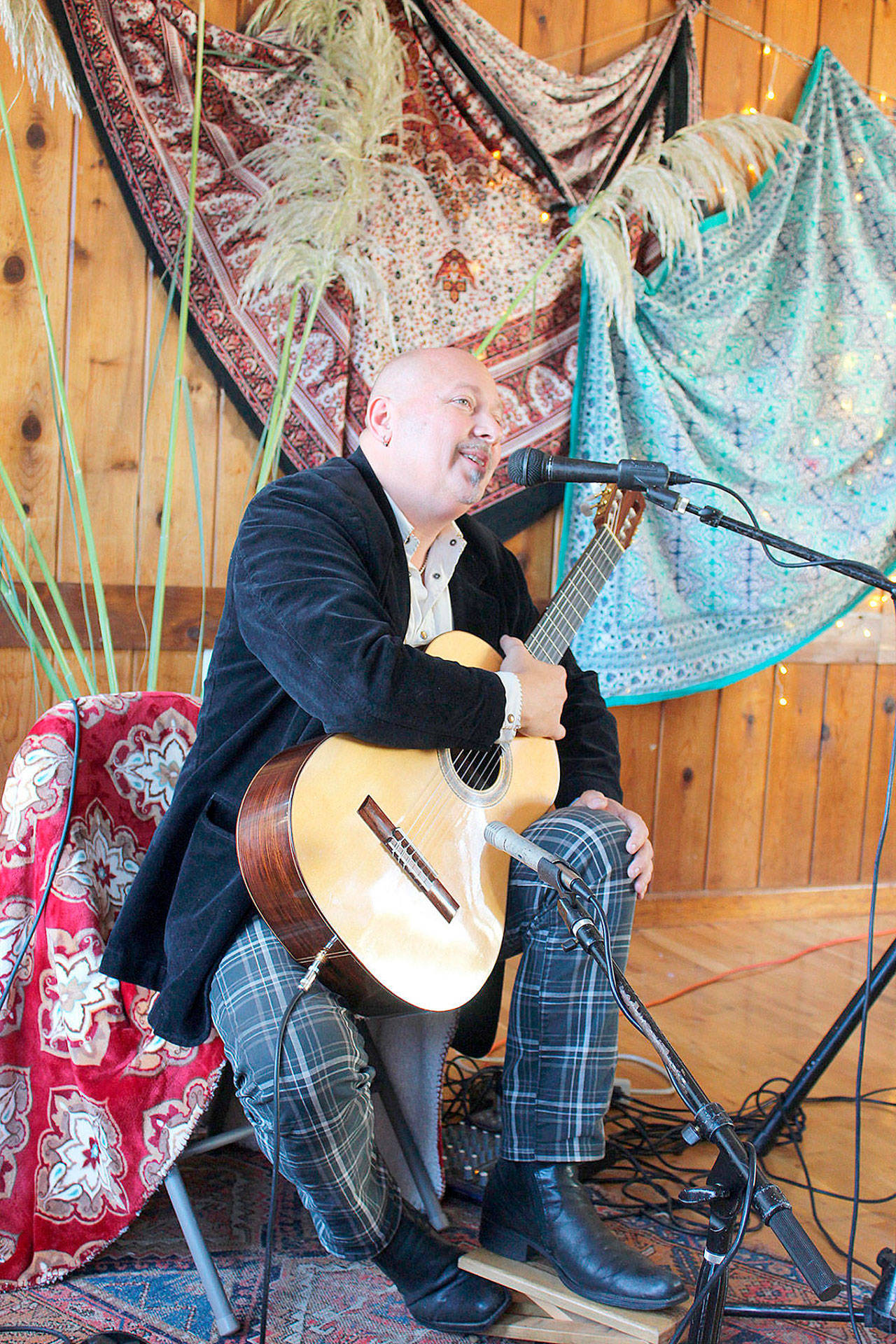 File photo/Whidbey News Group.                                Classical guitarist Andre Feriante of Langley plays at a gathering of Island Bohemians last year. He’s hosting a guitar festival at two South Whidbey wineries Aug. 10-12.