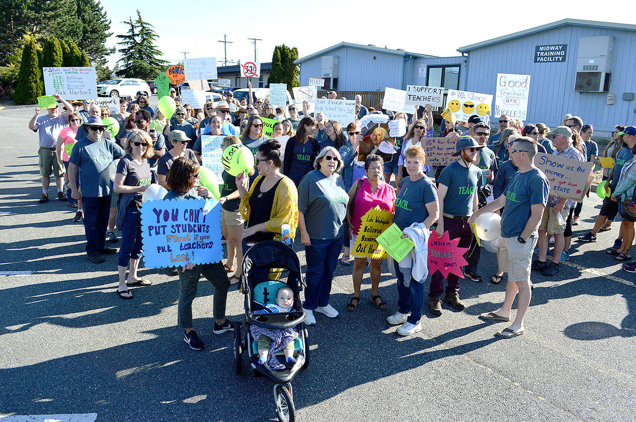 Around 120 Oak Harbor Education Association members gathered Tuesday morning in front of the Midway Training Facility, the sight of bargaining negotiations. Union members said Tuesday’s crowd had double the number of a similar rally last year. Photo by Laura Guido/Whidbey News-Times