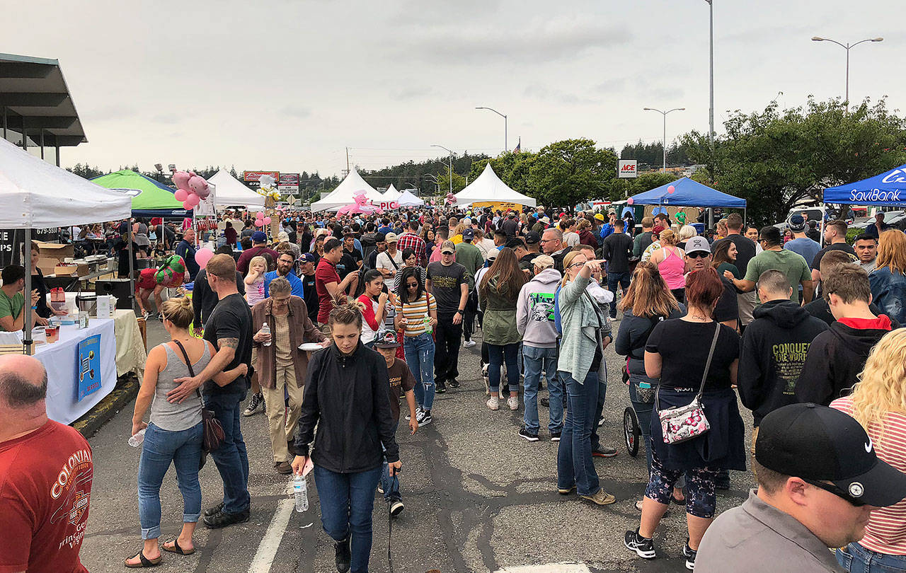 Thousands of people came to the 11th annual Pigfest in Oak Harbor Sunday to try Scott Fraser’s barbecued pork from a potentially record-setting smoke pit. Photo by Emily Gilbert/Whidbey News-Times