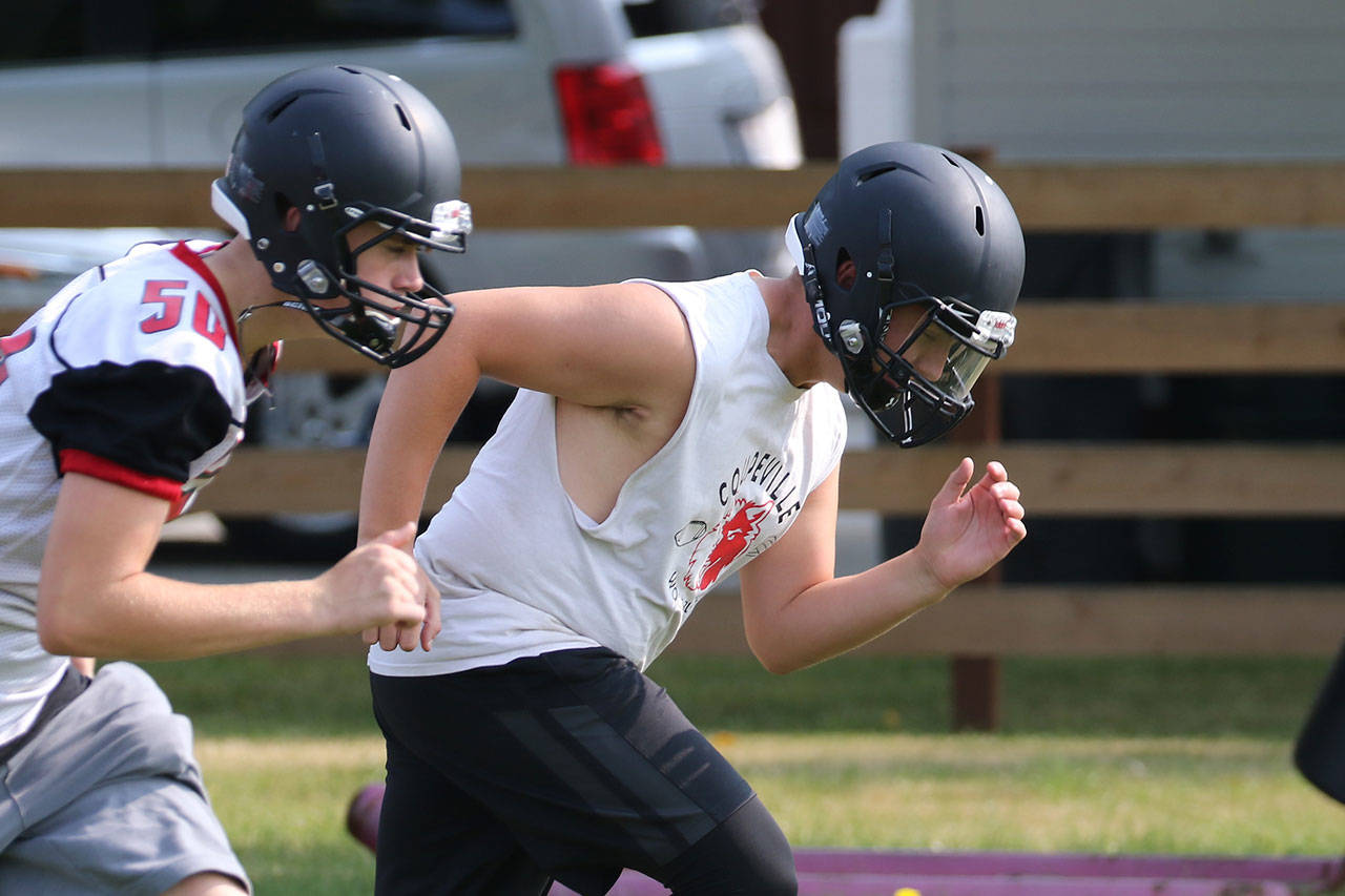 Coupeville football players run through conditioning drills Thursday as they prepare for their first season in the North Sound Conference. Changes proposed by the WIAA could end the Wolves’ stay in the new league. (Photo by John Fisken)