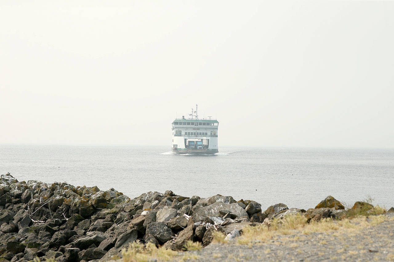 Photo by John Fisken                                A ferry headed to the Coupeville landing emerges out of smoky haze that’s blanketed the area.