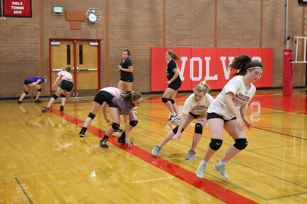 Volleyball players work on conditioning at practice Monday. (Photo by John Fisken)
