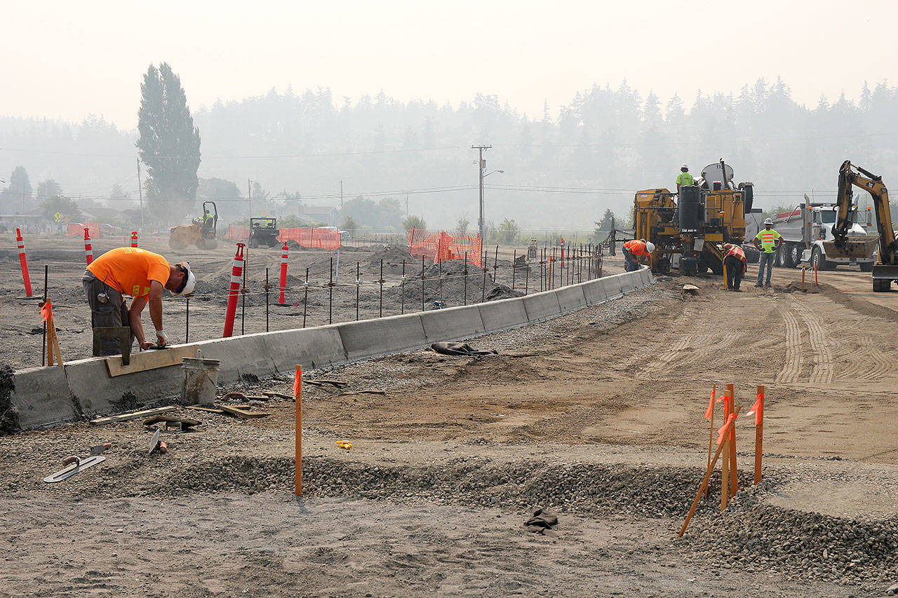 Photo by Jessie Stensland / Whidbey News-Times.                                Crews work on a curb for a parking lot in Windjammer Park Monday.