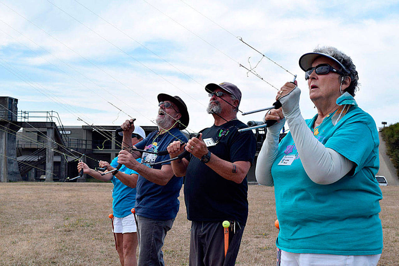 File photo./Whidbey News-Times                                The Whidbey Island Kite Fliers will once again host their popular festival. Festival chair Lisa Root (right) joins others from Whidbey Island Kite Fliers in a team flight last year.