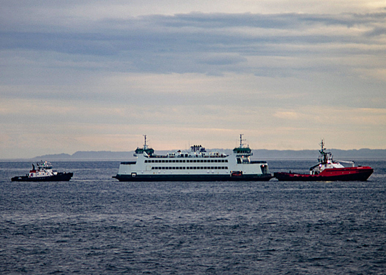 The Salish is towed by a tug boat back to Port Townsend after making a soft grounding in Keystone Harbor. The vessels rudder was damaged and the Coupeville-to-Port Townsend run will be down to one boat until it can be fixed. Photo by David Stern - Whidbey Custom Photography