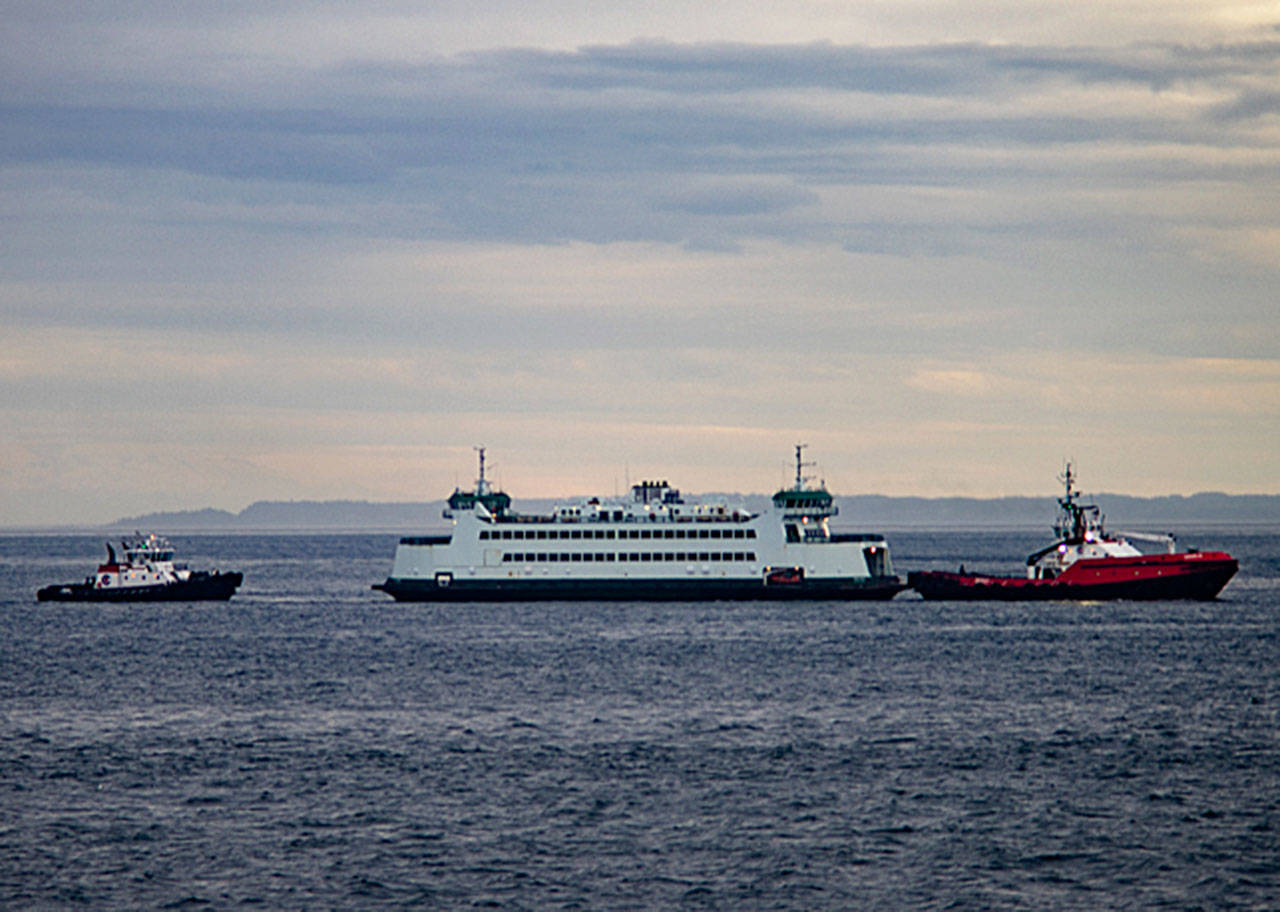 The Salish is towed by a tug boat back to Port Townsend after making a soft grounding in Keystone Harbor. The vessel’s rudder was damaged and the Coupeville-to-Port Townsend run will be down to one boat until it can be fixed. Photo by David Stern - Whidbey Custom Photography