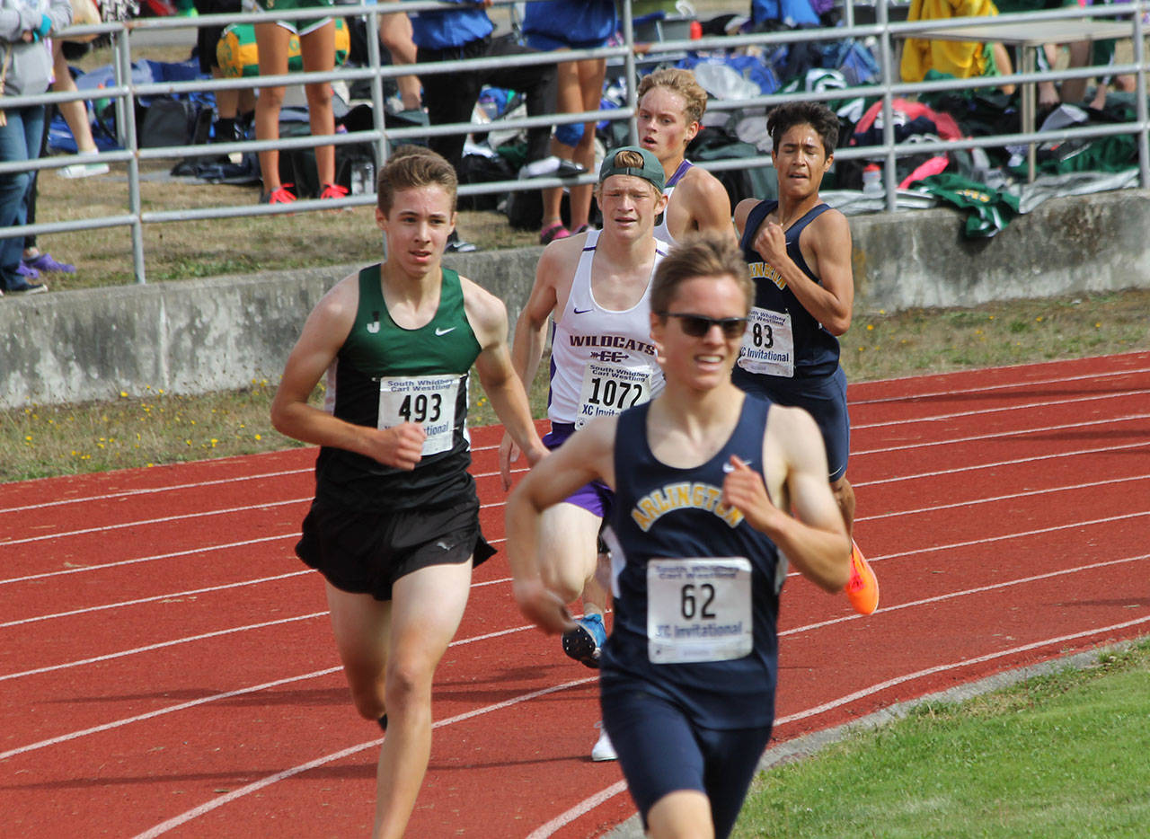 Oak Harbor’s Dallas Riddle-Stevens (1072) heads toward the finish line in Saturday’s meet. (Photo by Jim Waller/Whidbey News-Times)