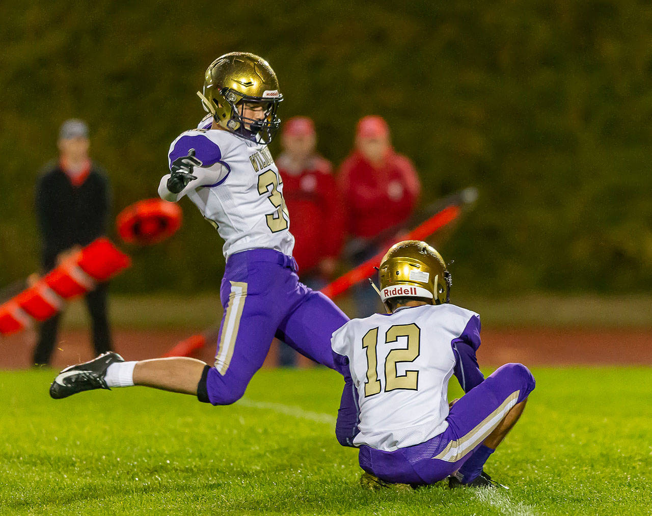 Jake Mitten kicks an extra point out of the hold of Caleb Fitzgerald.(Photo by John Fisken)