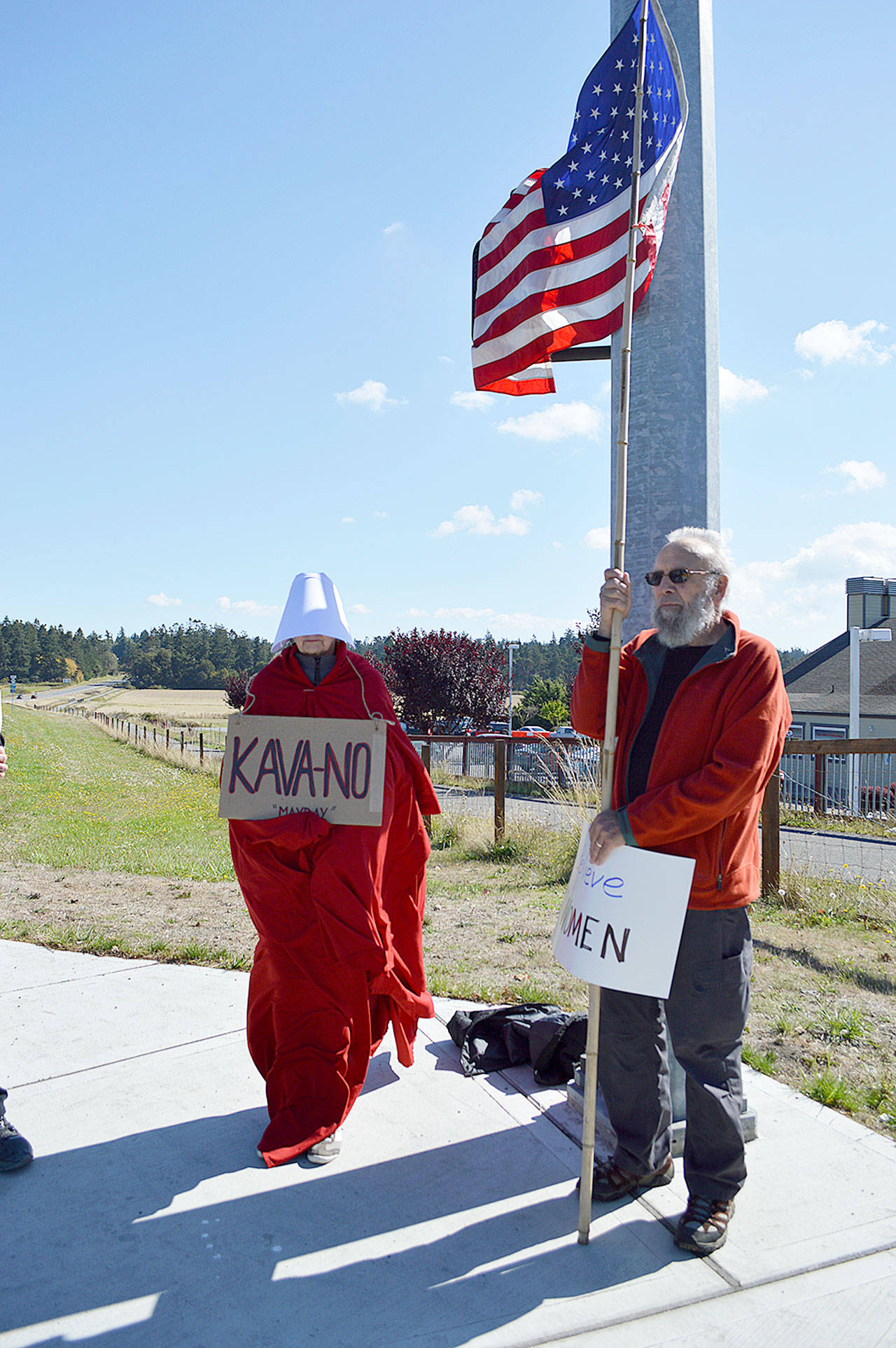 Marran Gray and Robert Gray stand at the corner of State Route 20 and Main Street in Coupeville Monday afternoon in protest of the Brett Kavanaugh’s nomination to the Supreme Court. Photo by Laura Guido/Whidbey News-Times