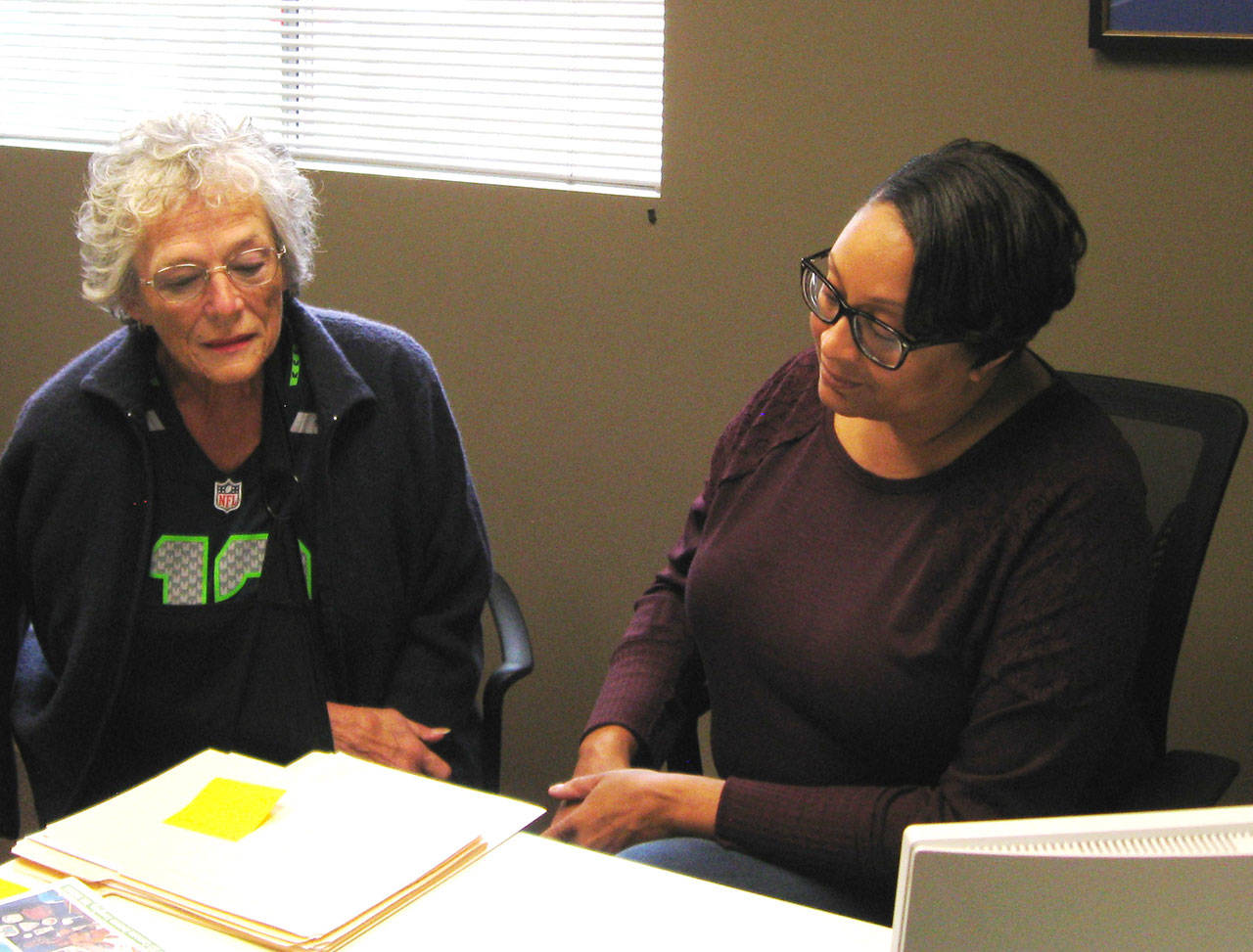 Photo by Dave Felice                                <em>Maureen MacDonald (left) of the Genealogical Society of South Whidbey Island looks at documents with Island County Historical Society archivist Cassie Rittierodt.</em>