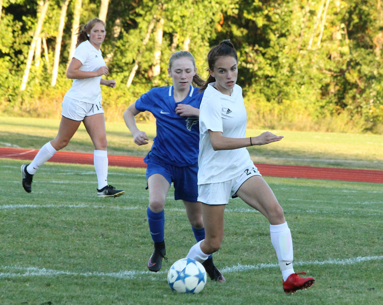 Mallory Kortuem beats a South Whidbey player to the ball.(Photo by Jim Waller/Whidbey News-Times)