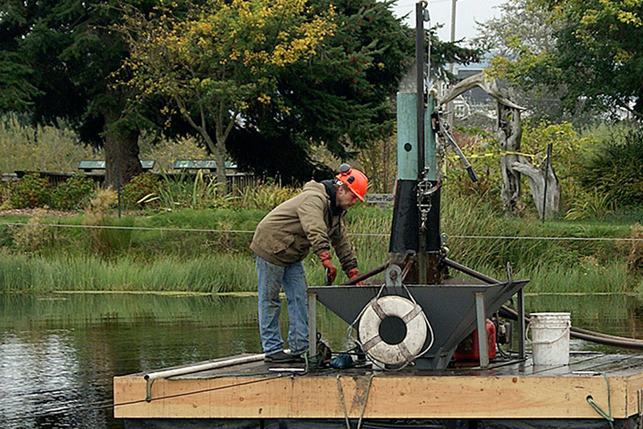 Photo by Maria Matson / Whidbey News-Times                                Mike Brown runs the machine that is extracting goose and duck poop from the bottom of the Greenbank Farm pond.