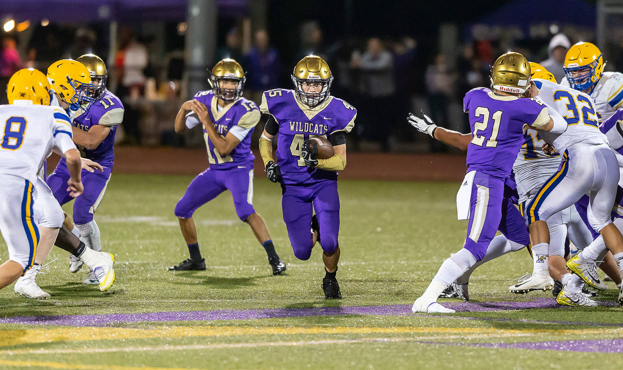 Caden Leckelt (45) rushes through a huge hole created in part by Aaron Martinez (11) and Calvin Whelpley (21) as quarterback Caleb Fitzgerald looks on.(Photo by John Fisken)