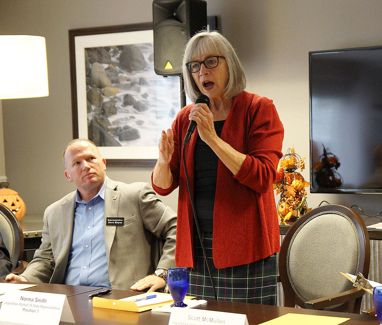 Rep. Norma Smith, R-Clinton, speaks at a forum Monday morning at Regency on Whidbey while Rep. Dave Hayes, R-Camano Island, looks on. A representative for Dave Paul and candidate Scott McMullen also attended the event. Photo by Laura Guido/Whidbey News Group