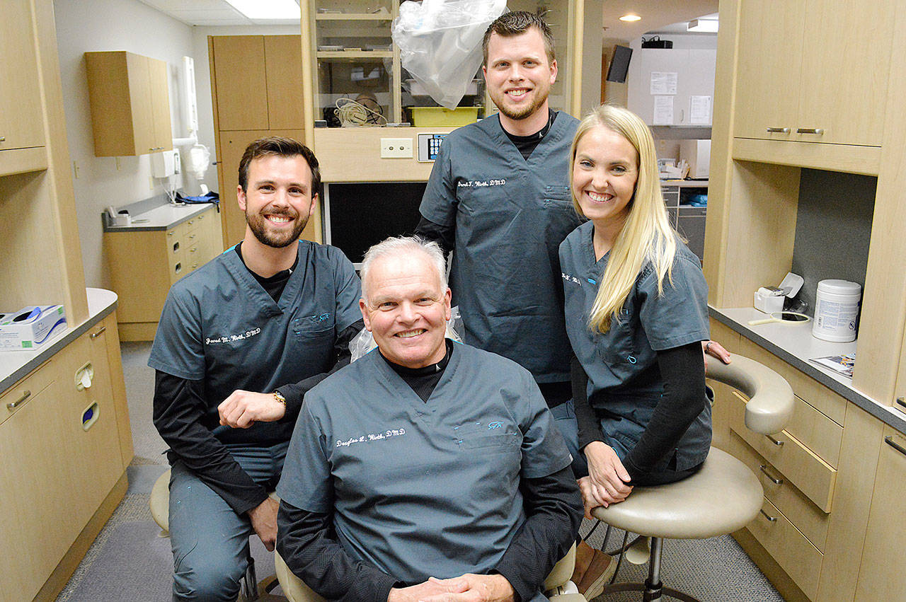 Doug Wirth, center, and his sons Jared, left, and Derek all practice dentistry together with Derek’s wife Hope Wirth. Photo by Laura Guido/Whidbey News-Times