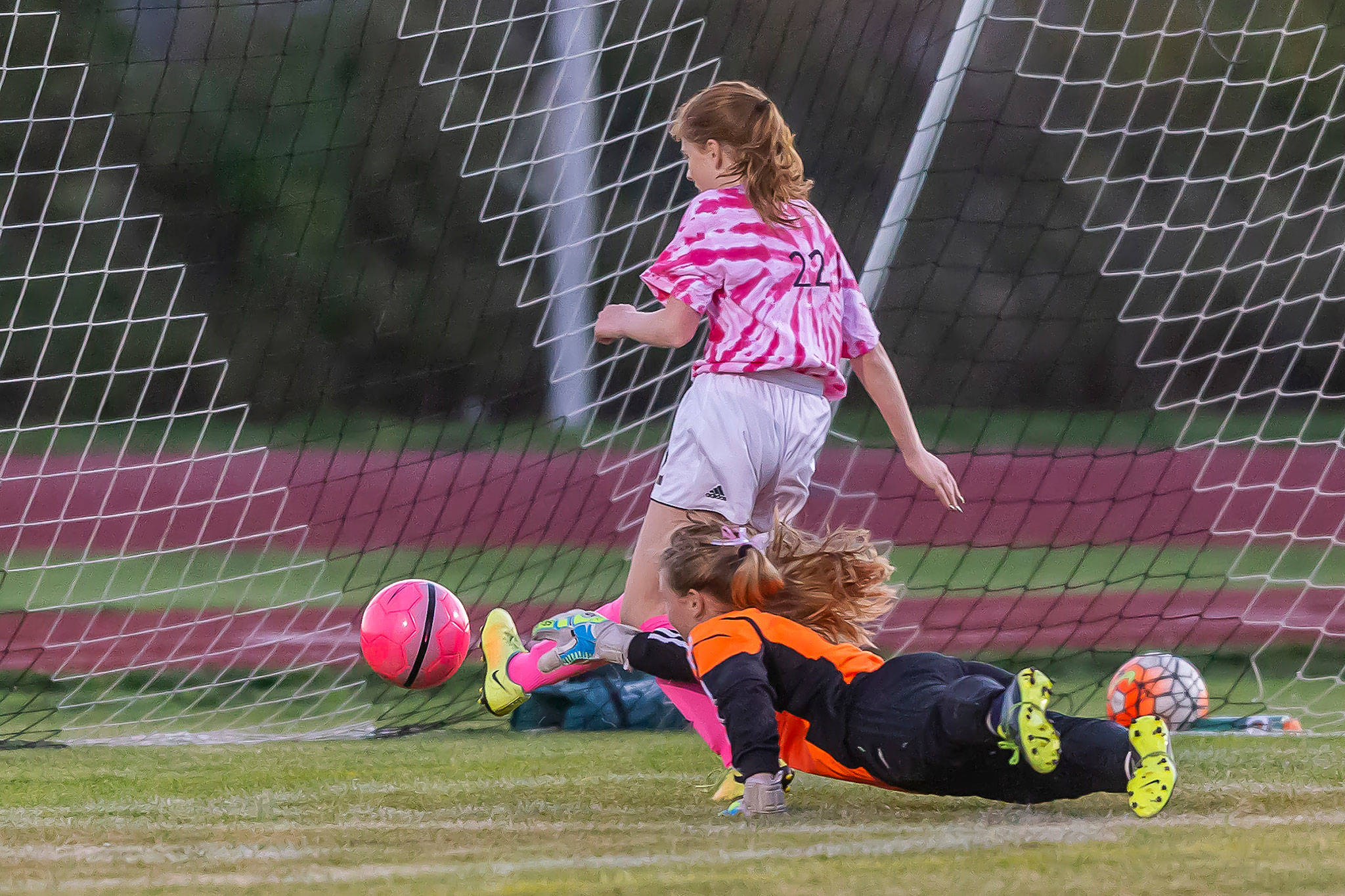 Anna Dion punches in a goal for Coupeville. (Photo by John Fisken)