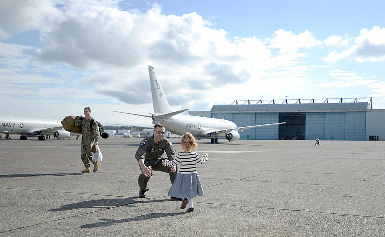 Lt.Cmdr. John Bartis, a pilot assigned to the “Skinny Dragons” of Patrol Squadron 4, reunites with his daughter following a successful seven-month deployment in the U.S. 7th Fleet area of responsibility.