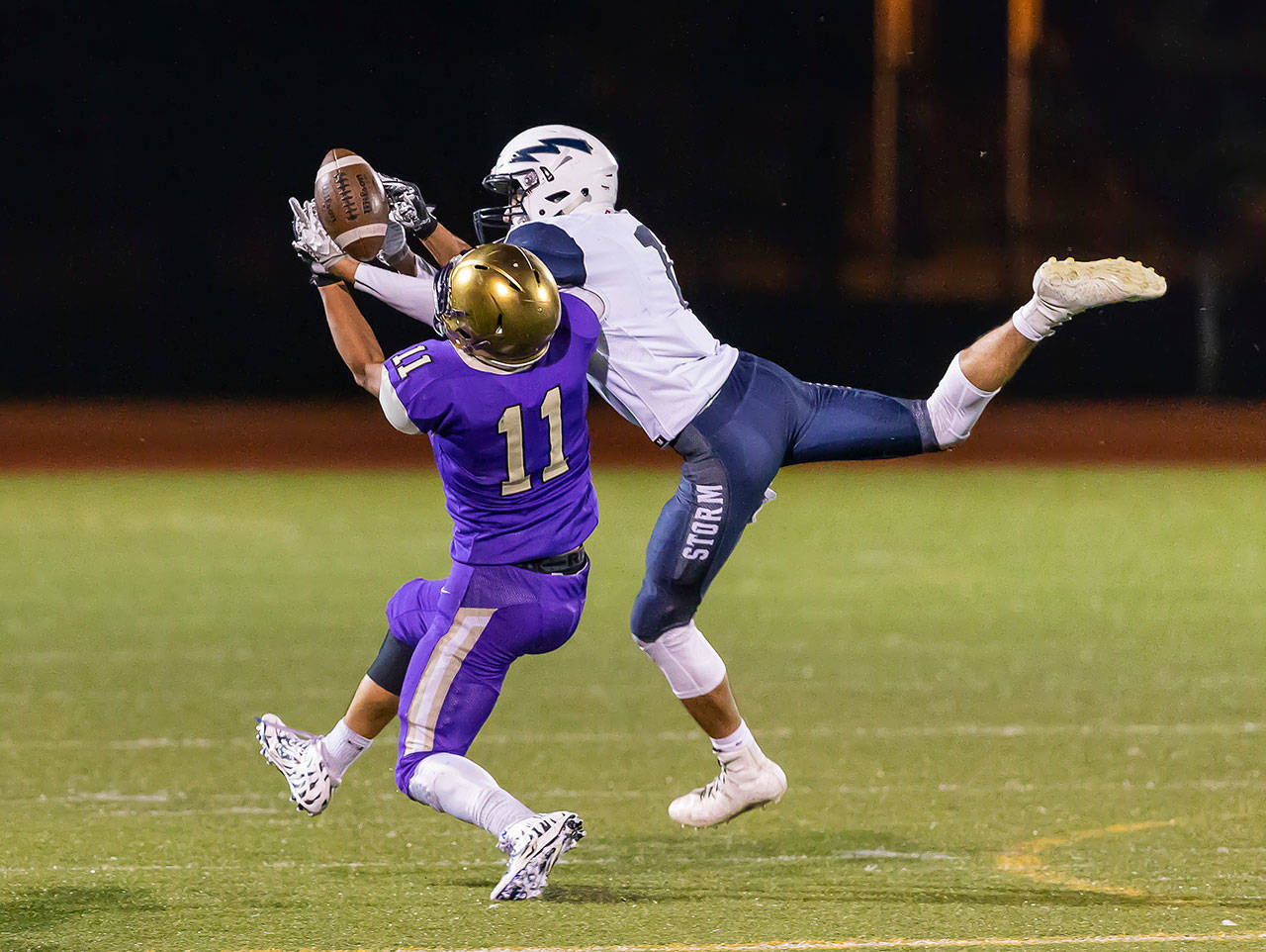 Aaron Martinez wrestles a catch away from the Squalicum defender Friday.(Photo by John Fisken)