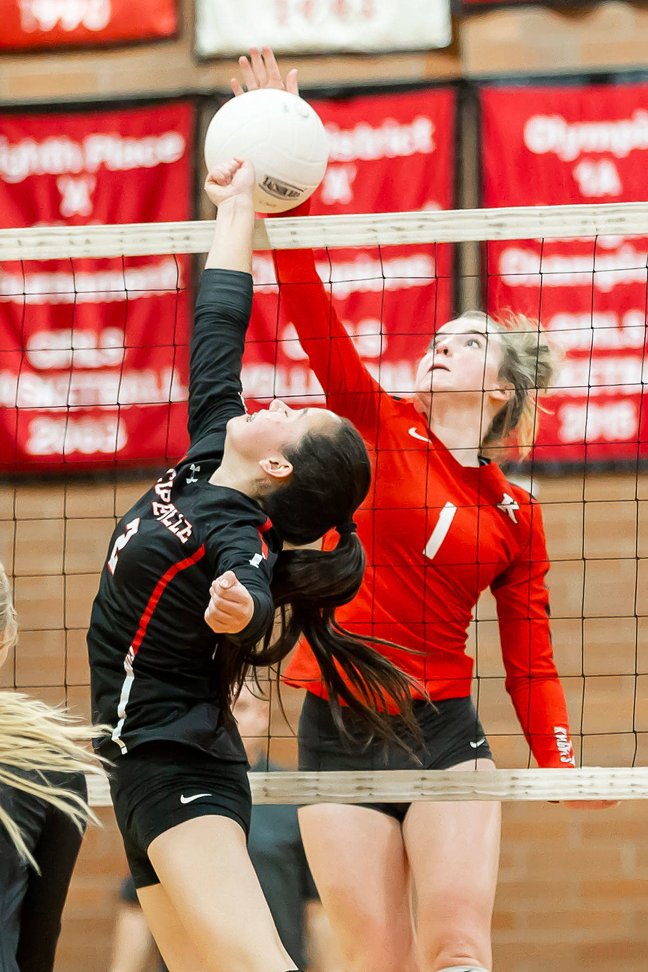 Scout Smith challenges King’s Ava Mason (1) for a ball just above the net.(Photo by John Fisken)