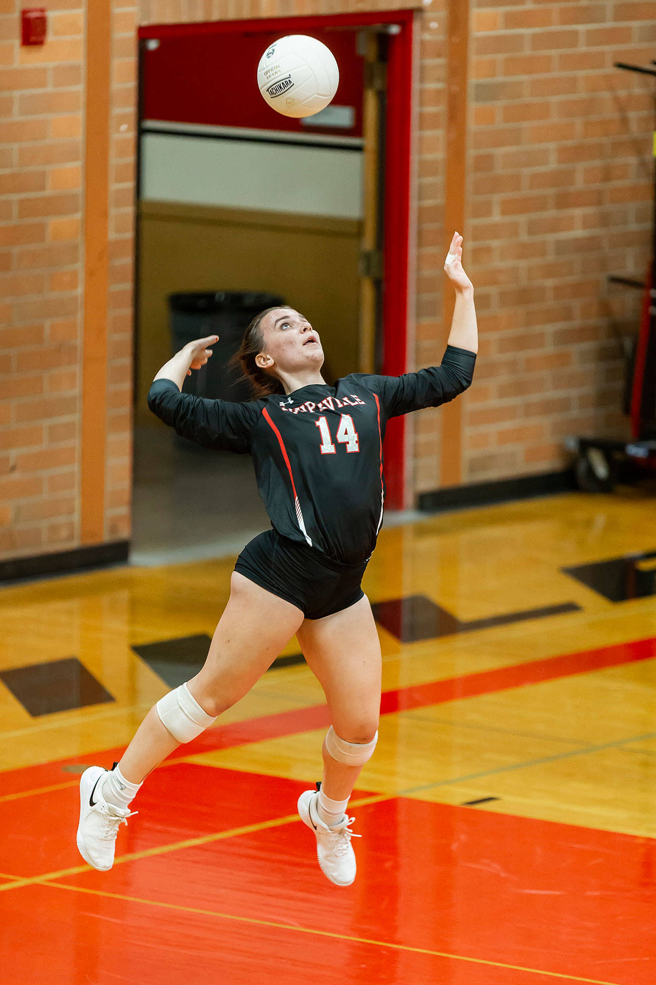 Ashley Menges launches a serve Wednesday.(Photo by John Fisken)