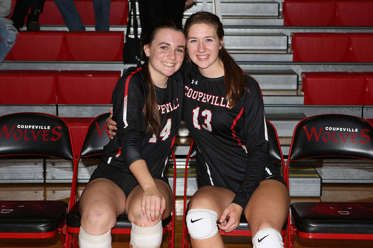 Coupeville seniors Ashley Mengers, left, and Emma Smith embrace before playing their final home match Wednesday.(Photo by John Fisken)