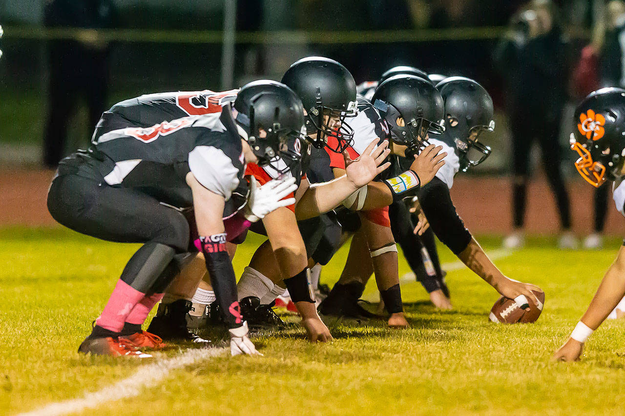 The Coupeville offensive line gets ready to fire off the ball.