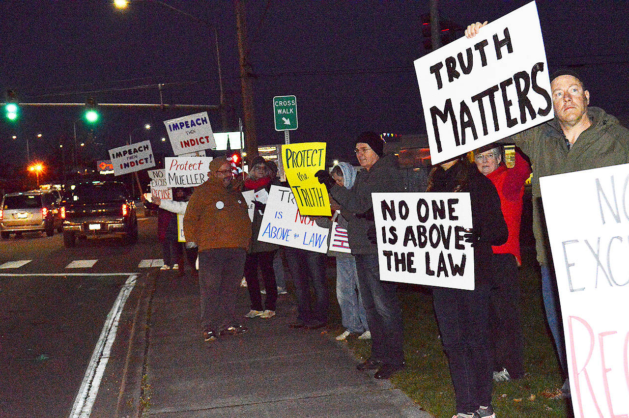 More than 40 people braved the cold Thursday night in Oak Harbor to protest the appointment of Matthew Whitaker as acting attorney general. Photo by Laura Guido/Whidbey News-Times